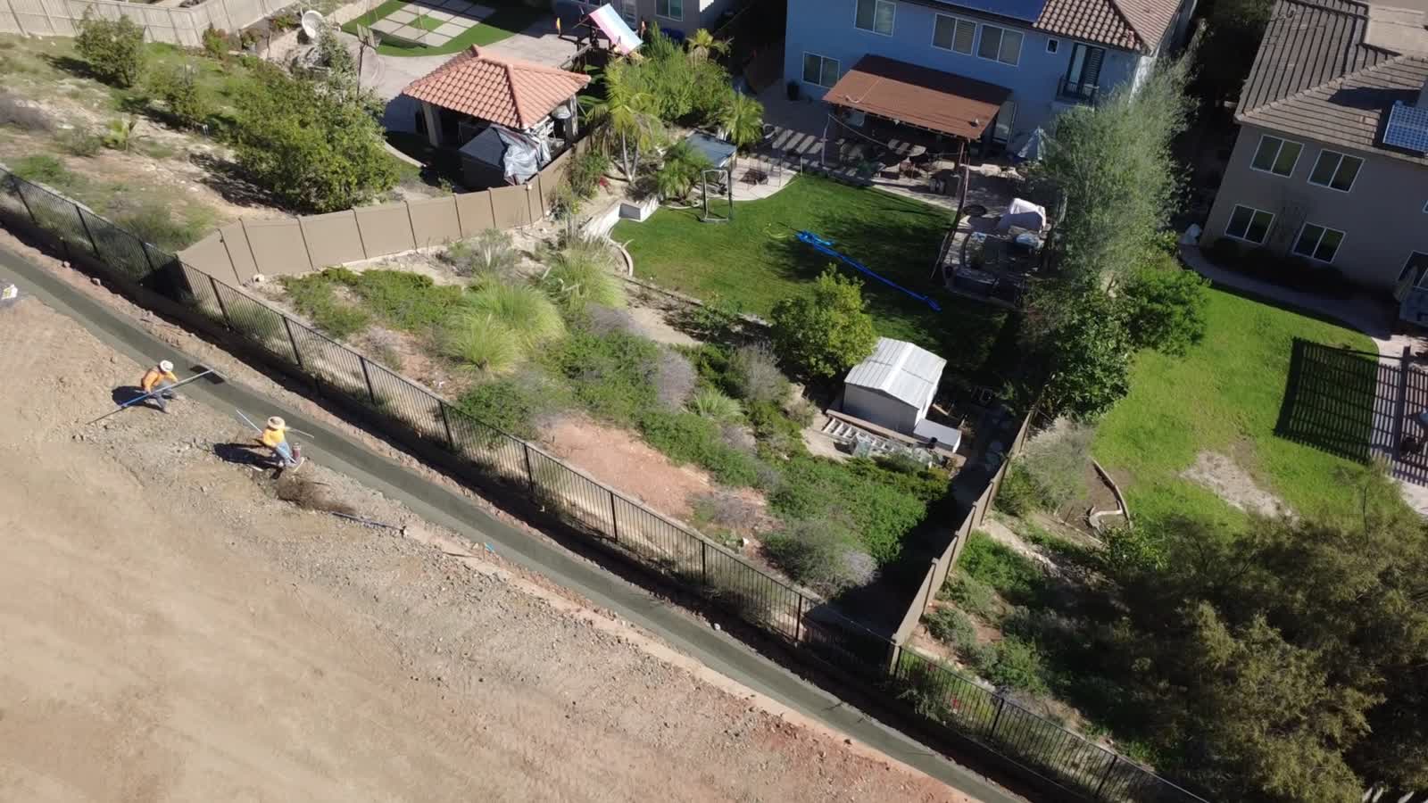 Crew working in a V-ditch along a fence line