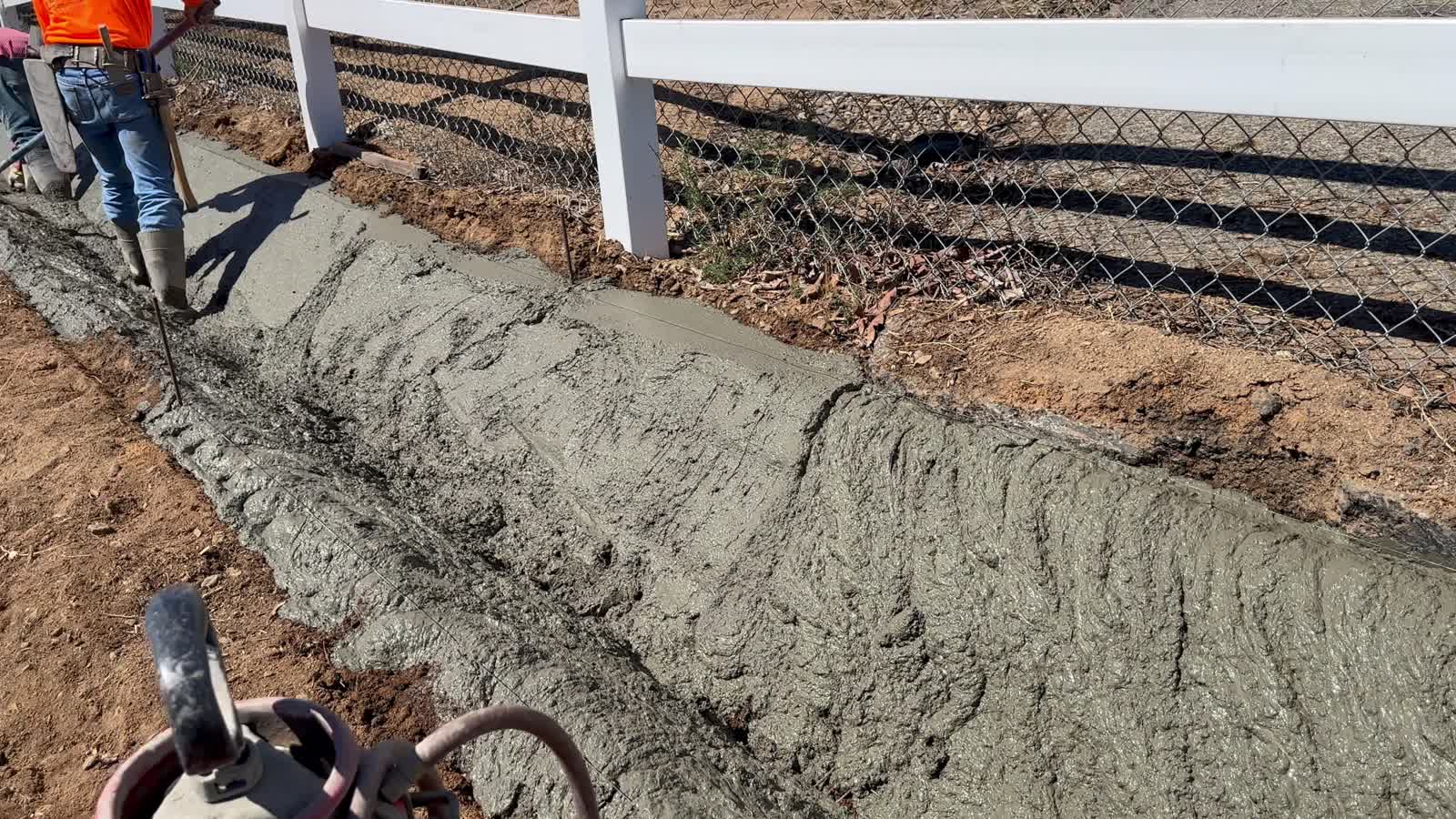 Crew grading a V-ditch on a hillside